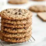 A stack of oatmeal chocolate chip cookies on a white marble table showcasing how to freeze oatmeal chocolate chip cookies