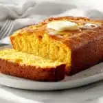 Featured image of freshly baked cornbread showing soft texture, perfect for learning what ingredient keeps cornbread from crumbling