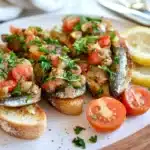 What is the best way to eat canned sardines served on sourdough bread with herbs and lemon