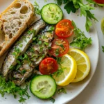 A beautifully plated dish featuring tinned sardines, fresh vegetables, and sourdough bread